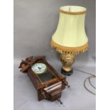 A reproduction Vienna style wall clock together with a Seville style table lamp with shade,