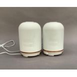 A pair of Neom wellbeing essential oil diffuser pods