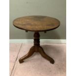 A mid 19th century oak tripod table, the snap top above a turned column, three flat scrolled legs,