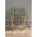 A lacquered brass framed two tier occasional table, the canted glass top inset above corinthian