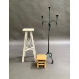 A three light candle stand in green finished metal on tripod base, together with a white plant stand