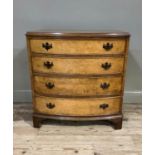 A reproduction burr walnut veneered bow front chest in George III style, the butterfly veneered