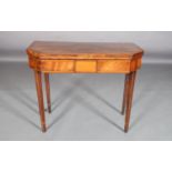 A GEORGE III FIGURED MAHOGANY CANTED RECTANGULAR CARD TABLE, outlined throughout with broad