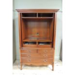 A reproduction cherry wood veneered TV /press cupboard, with flared cornice, raised fielded panelled