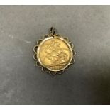 A Victorian 1900 veil head sovereign channel set as a pendant in 9ct gold with hoop wire surround,