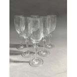 A set of six slender glasses etched with classical urns and swags