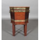 A GEORGE III BRASS BOUND MAHOGANY HEXAGONAL CELLARETTE, conventional design, moulded legs, brass