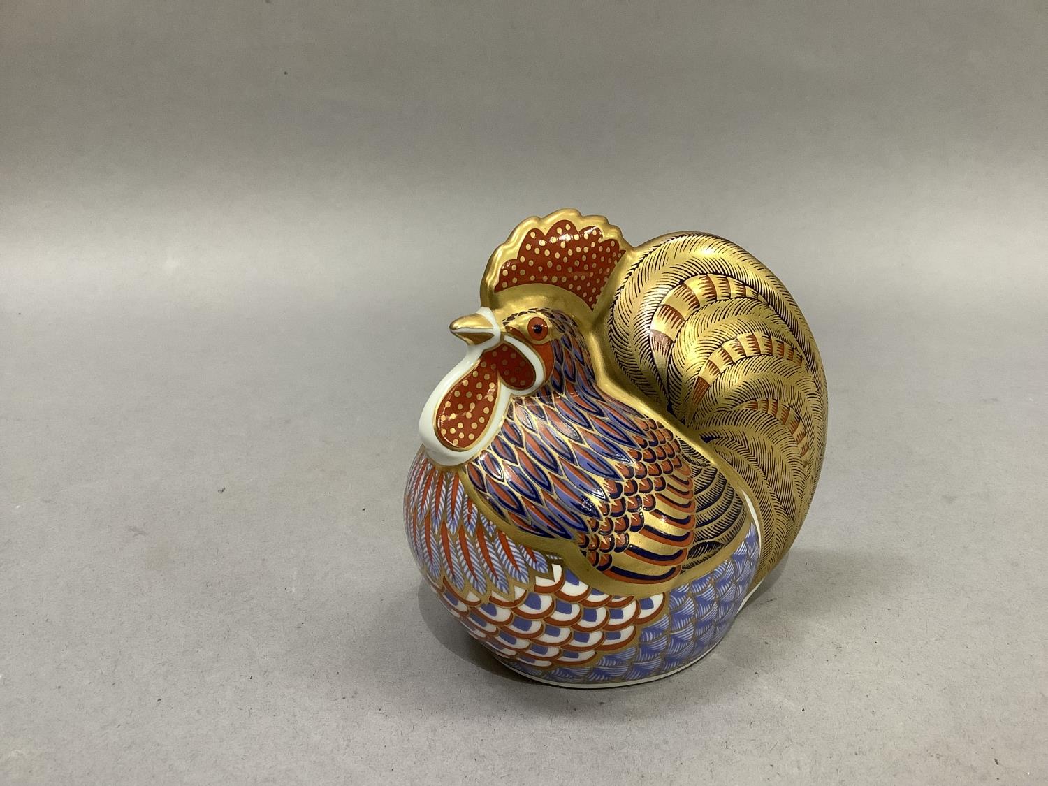 A Royal Crown Derby cockerel paperweight with gold button, 10cm wide, 10cm high