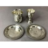 Four pieces of .900 silver including beaker, egg cup and two circular pin trays, 10cm, each piece