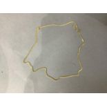 A neckchain in facetted curb links of yellow metal (tests as 18ct gold), approximate length 54cm,