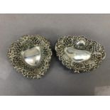 Two silver heart shaped sweetmeat dishes, each of heart shape with hatched and vacant cartouche or