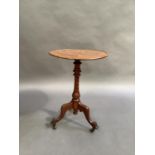 A Victorian mahogany tripod table, the circular top on spiral fluted baluster column, three outswept