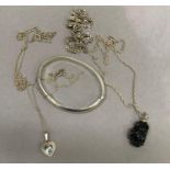 A small collection of silver jewellery including a mineral crystal pendant, blue paste set heart