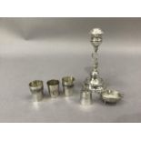 A .800 silver candlestick with dolphin column on domed base, a pair of far Eastern white metal