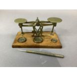 An Edwardian mahogany and brass set of postal scales with weights for 0.5oz, 1oz and 2oz together