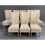 A set of eight oak framed dining chairs upholstered in cream and beige damask, tapered legs