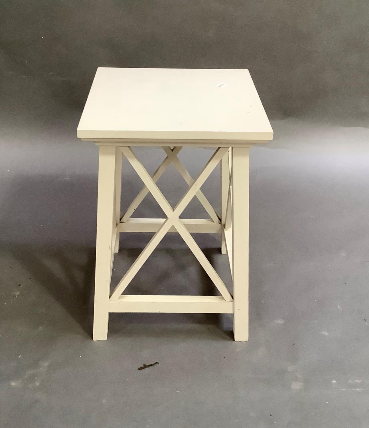 A cream painted square stand with X-frame sides on square legs, top 34cm square