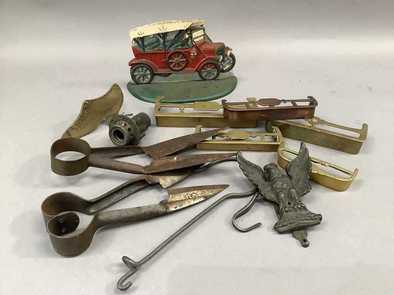 Two iron topiary shears, four brass miniature hearth fenders and another in copper, a cast iron door