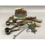 Two iron topiary shears, four brass miniature hearth fenders and another in copper, a cast iron door