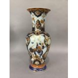 A German Kaiser porcelain vase painted with peacocks perched in a blossom tree against a gilt iron