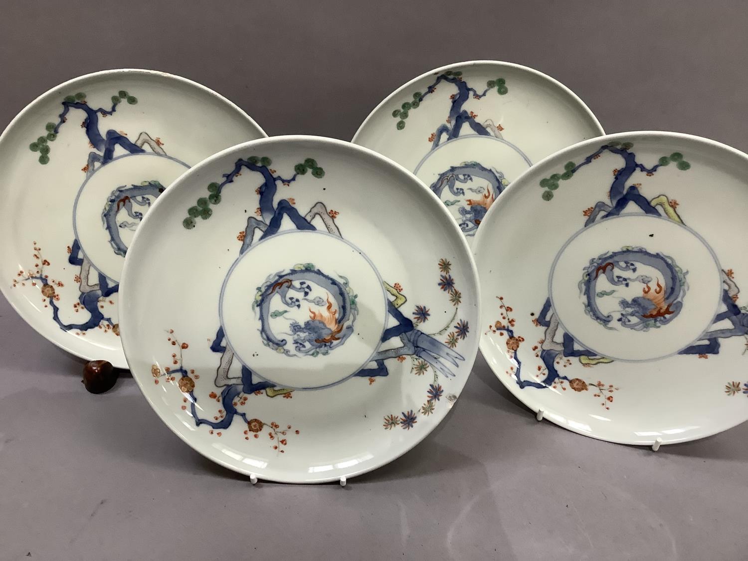 A set of four Japanese porcelain plates, each decorated to the centre with a stylised dragon, the - Image 3 of 6