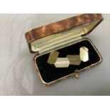 A pair of cufflinks in 9ct gold c. 1955, the engine turned and polished hexagonal faces (a/f) joined