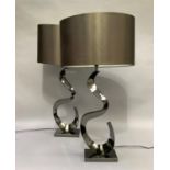 A pair of modern table lamps of S-Scroll form on rectangular bases with oval brown 'satin' shades