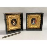 A pair of late 19th century oval portrait miniatures; one of a young girl holding a candle, the