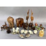 A quantity of carved wooden elephant figures, other wooden figures, ceramic birds by Beswick and