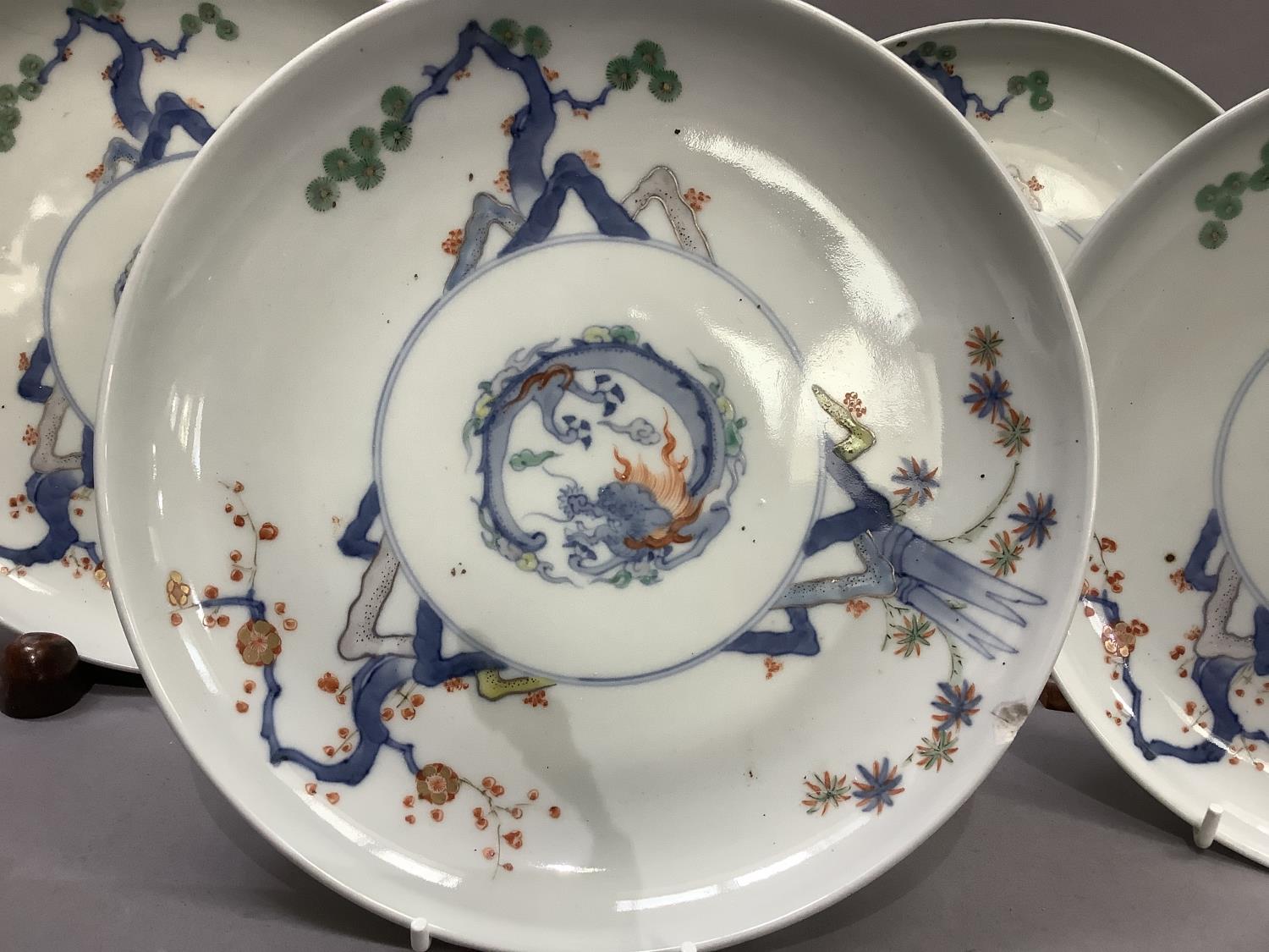 A set of four Japanese porcelain plates, each decorated to the centre with a stylised dragon, the - Image 5 of 6