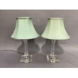 A pair of perspex table lamps with green silk shades
