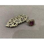 A marcasite cluster ring in silver set to the centre with a step cut purple paste together with an