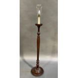 A mahogany standard lamp with fluted inverted baluster pillar with waisted fluted upper section,