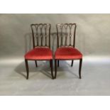 A pair of Edwardian Chippendale style bedroom chairs with interlaced pierced splats, stuffed over
