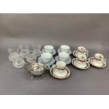 A set of four Royal Worcester Holly Ribbons coffee cans and saucers together with a set of four