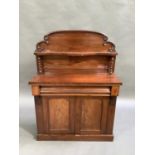 A Victorian mahogany chiffonier, the panelled back with serpentine shelf supported by pair of barley