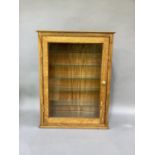 A reproduction oak wall mounted display cabinet enclosed by a glazed door, adjustable glazed