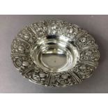 A continental .925 silver bowl, the flared rim embossed with panels of fruit and flowers on three