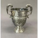 A George V silver two handled trophy cup on circular foot, engraved inscription Tidworth R.A.T.A