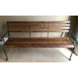 A slatted garden bench with green painted metal ends, 165cm wide max