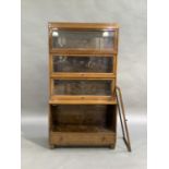 A Globe Wernicke four stack bookcase with glazed doors on single drawer base and tapered block legs,