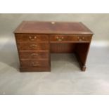 A reproduction mahogany single pedestal desk in George III style, the rectangular top inset gilt