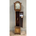 An Edwardian mahogany grandmother clock, the silvered dial with chaptering of Roman numerals,