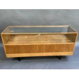 An oak shop display cabinet, rectangular outline with glazed top, front and back, with sliding