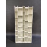 A set of white painted open wall shelves of irregular design, 180cm high, 86cm wide