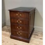 A reproduction mahogany two drawer filing cabinet, the rectangular top inset with gilt tooled