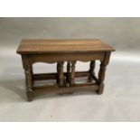 A set of three reproduction oak occasional tables, the largest with rectangular top, on turned