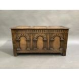 A reproduction oak blanket chest in late 17th century style, the three panel hinged lid above a