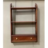 A reproduction mahogany wall shelf with fret pierced sides and fitted cockbeaded drawer, 41cm wide x