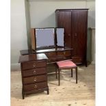 A Stag furniture four piece bedroom suite comprising wardrobe, chest of drawers, dressing table